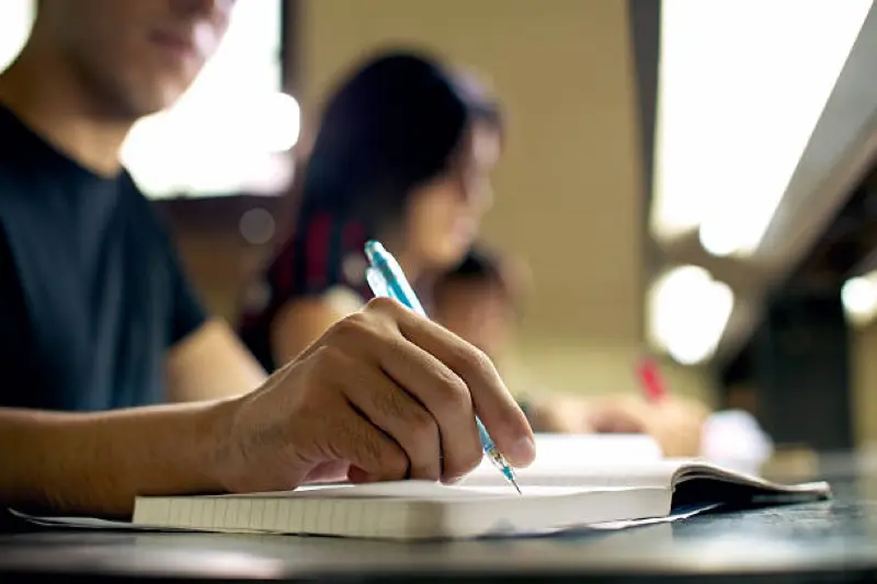 hand writes in notebook, small tactile learning class